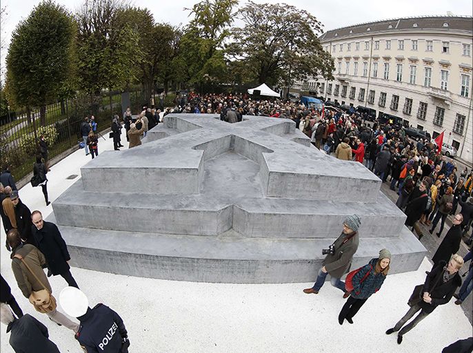 People attend the unveiling of a monument dedicated to deserters of the Wehrmacht, the unified armed forces of the Nazi regime, on October 24, 2014 atin Vienna
