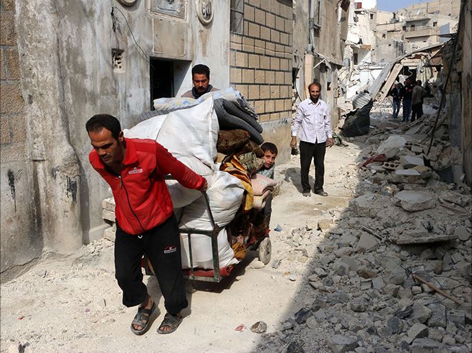 Syrians transport re-usable items found in the rubble of buildings in the Kalasa neighbourhood of the northern Syrian city of Aleppo on October 28, 2014. Aleppo has been divided since a rebel offensive in summer 2012 between loyalist sectors on its west side and rebel territory on the east. AFP PHOTO / BARAA AL-HALABI