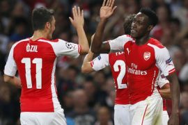 Arsenal's Danny Welbeck (R) celebrates with teammate Mesut Ozil after scoring a second goal during their Champions League soccer match against Galatasaray at the Emirates Stadium in London October 1, 2014. REUTERS/Stefan Wermuth (BRITAIN - Tags: SPORT SOCCER)