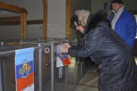 A local election committee member pastes a flag of the self-declared Luhansk People's Republic on a ballot box at a polling station in Luhansk, Ukraine, 30 October 2014. Pro-Russian separatists prepare to hold elections of their leaders and parliaments in both the self-proclaimed Donetsk and Luhansk 'people's republics' on 02 November 2014. Ukraine and western governments have denounced the elections as illegal and as a threat to last month's ceasefire accord.