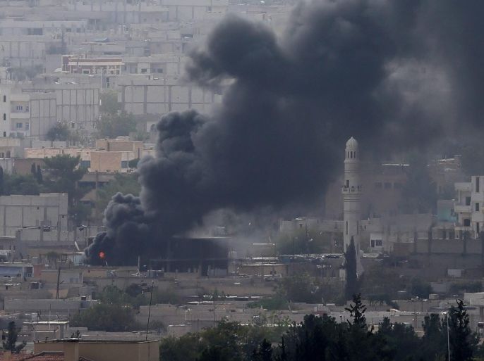 A picture taken from Turkey showing smoke rising during armed clashes between Islamic State and Kurdish fighters YPG who are trying to defend Kobane,Syria, near Suruc district, Sanliurfa, Turkey 10 October 2014. Islamic State militants captured part of a strategic hill overlooking the southern entrance to the besieged Kurdish town of Kobane on Syria's border with Turkey, a monitoring group said. The Islamic State's reported advance came despite what appeared to be the most intense airstrikes yet on jihadist forces around the town by a US-led coalition that formed to fight the militants.