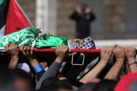 Palestinian mourners carry the body of 14-year old Orwa Hammad, who was killed two days earlier in clashes with Israeli security forces during his funeral in the West Bank village of Silwad, north of Ramallah. The Israeli army said Hammad had been about to hurl a petrol bomb at Israeli motorists near Ramallah when he was shot by troops on a stakeout in the village of Silwad to protect a road frequently used by Jewish settlers. AFP PHOTO/ABBAS MOMANI