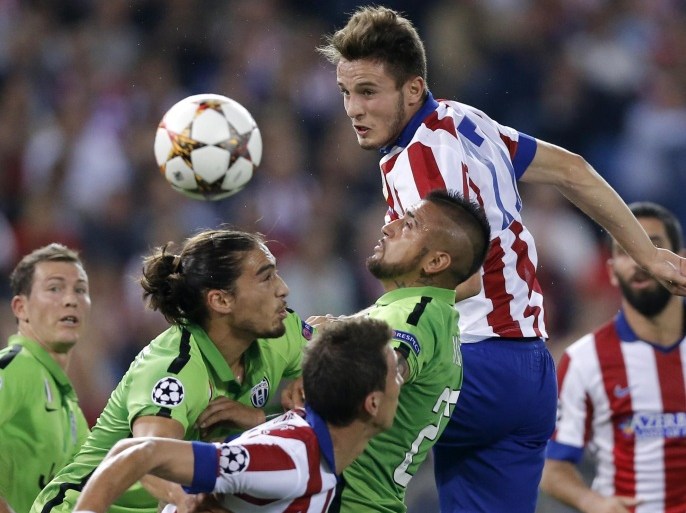 Atletico's Saul, up, eyes the ball during the Group A Champions League soccer match between Atletico De Madrid and Juventus at the Vicente Calderon stadium in Madrid, Spain, Wednesday, Oct. 1, 2014. (AP Photo/Daniel Ochoa de Olza)