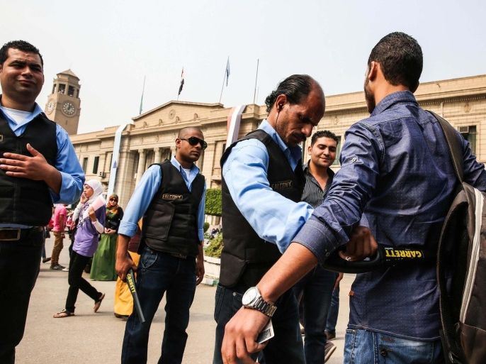 CAIRO, EGYPT - OCTOBER 21: Egyptian students pass through body search with a metal detector as part of strict security measures taken by the Egyptian government to prevent the demonstrations in the entrance to Cairo University, Egypt on October 21, 2014.