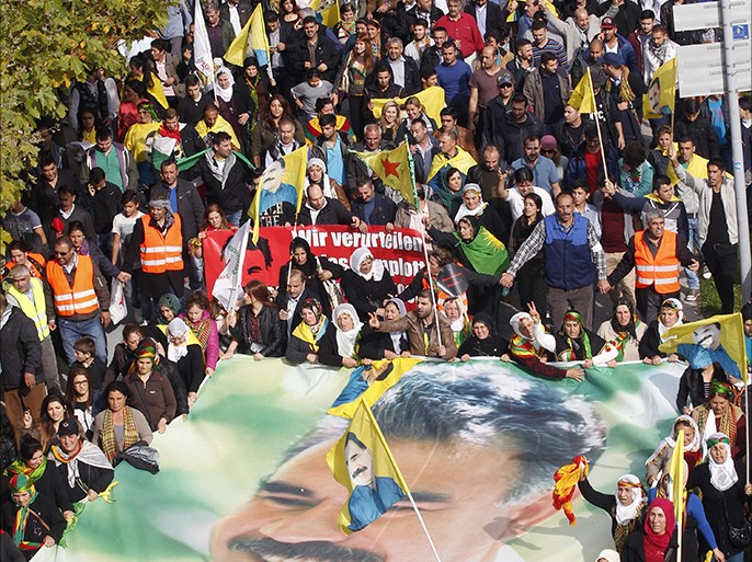 An aerial view shows pro-kurdish demonstrators holding a giant portrait Abdullah Ocalan, the founder of the militant organization the Kurdistan Workers' Party (PKK), as they gather on October 11, 2014 in Duesseldorf, north-western Germany, during a rally in solidarity with Kurds trapped in the northern Syrian city of Kobane where they are besieged by Islamic State (IS) jihadist militants. Turkey has recently tightened security of its porous Syrian border after the escalating fighting in Kobane sparked the exodus of 200,000 refugees