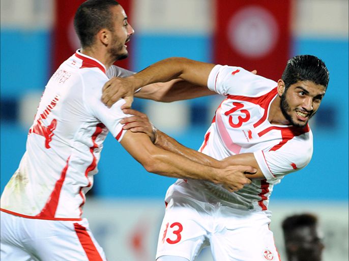 Tunisia's foward Ferjani Sassi (R) celebrates with Tunisia's forward Stephane Houcine Nater (L) after scoring a goal during the 2015 Africa Cup of Nations qualifying football match at the Ben Jannet Olympic stadium in Monastir on October 15, 2014. AFP PHOTO/ SALAH HABIBI