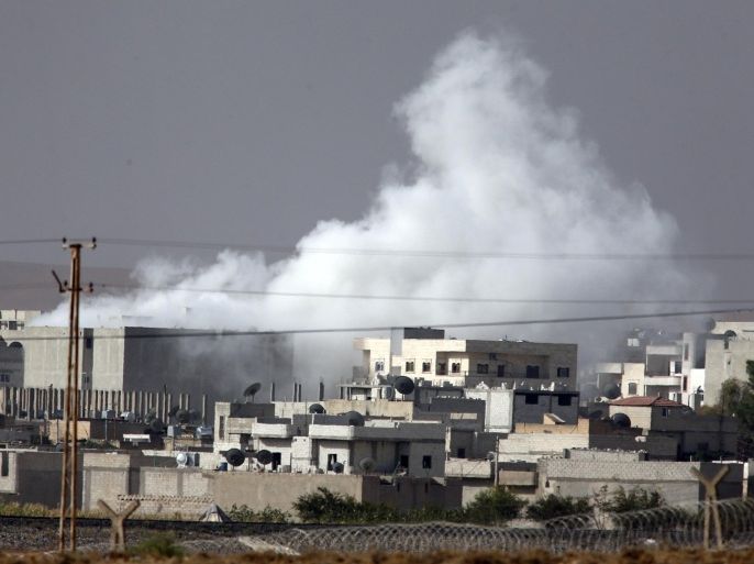 Smoke from a military strike rises in Kobani, Syria, as fighting intensified between Syrian Kurds and the militants of Islamic State group, as seen from Mursitpinar in the outskirts of Suruc, Turkey, at the Turkey-Syria border, Friday, Oct. 10, 2014. Kobani, also known as Ayn Arab, and its surrounding areas, has been under assault by the Islamic State group since mid-September and is being defended by Kurdish fighters. (AP Photo/Lefteris Pitarakis)