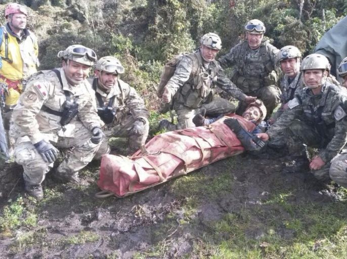 Rescue members pose for a picture with Spanish speleologist Cecilio Lopez-Tercero (C) after he was rescued from a cave where he was trapped for 12 days, in Leymebamba, Chachapoyas, in this handout photograph distributed to the media on September 30, 2014. A Spanish speleologist trapped 400 meters (1,312 feet) underground in a cave in the Peruvian Amazon for nearly two weeks was pulled to safety on Tuesday, a rescue worker said. Lopez-Tercero was stuck in the cave, named Intimachay, for 12 days in Peru's northern Amazonas region, where the temperature can drop as low as 10 degrees Celsius and humidity reaches 100 percent. REUTERS/Peruvian Air Force/Handout via Reuters (PERU - Tags: SOCIETY DISASTER ENVIRONMENT) ATTENTION EDITORS - THIS PICTURE WAS PROVIDED BY A THIRD PARTY. REUTERS IS UNABLE TO INDEPENDENTLY VERIFY THE AUTHENTICITY, CONTENT, LOCATION OR DATE OF THIS IMAGE. THIS PICTURE IS DISTRIBUTED EXACTLY AS RECEIVED BY REUTERS, AS A SERVICE TO CLIENTS. FOR EDITORIAL USE ONLY. NOT FOR SALE FOR MARKETING OR ADVERTISING CAMPAIGNS