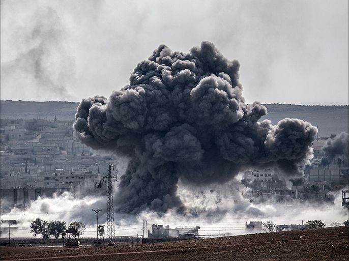 A picture taken from the Turkish border near the southeastern village of Mursitpinar, in the provience of Sanliurfa shows smoke billowing after a jet fighter hit Kobani, also known as Ain al-Arab, on October 28, 2014. Turkey wants the anti-Damascus Free Syrian Army (FSA) to control the Syrian border town of Kobane if Islamist jihadists are defeated, and not the forces of separatist Kurds or President Bashar al-Assad, Prime Minister Ahmet Davutoglu said. Turkey is fearful that Kobane could be taken over by Kurds allied to the Kurdistan Workers' Party (PKK) which has waged a three-decade insurgency for self rule and is regarded as a terrorist group by Turkey, the United States and most of Europe.AFP PHOTO/STRINGER