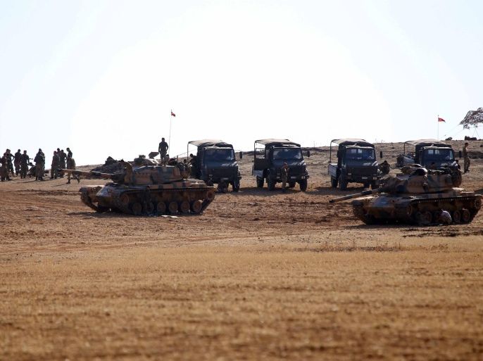 SANLIURFA, TURKEY - OCTOBER 08: Tanks and troops of Turkish Armed Forces are seen on the hills at the Turkey - Syria borderline, as the clashes near to the Turkish borderline continue in Ayn al-Arab city (Kobani), intensified between the Islamic State of Iraq and Levant (ISIL) militants and pro-Kurdish Democratic Union Party (PYD) forces, in Suruc district of Sanliurfa, southeastern province of Turkey on October 08, 2014.