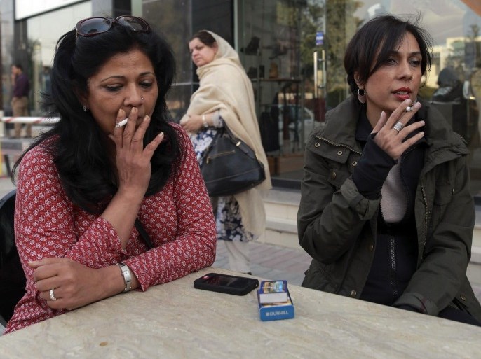 Pilates instructor Zainab Abbas (R) smokes a cigarette as she sits with a friend after lunch in Lahore February 19, 2014. Abbas opened her fitness studio, Route2Pilates, in Lahore, after receiving training in Bangkok, Thailand. She carries out rehabilitation workouts for people with joint problems as well as specialised workouts for pregnant women. Though instability continues to plague Pakistan and many areas are dominated by social conservatism, some of the country's more affluent residents have worked to fashion a very different kind of lifestyle for themselves. Pictures of men and women taking part in all sorts of activities and professions - from being a pilates instructor, to a textile retail entrepreneur, to a member of a rock band - offer a different view of Pakistan to images of conflict that often make the news. Picture taken February 19, 2014. REUTERS/Zohra Bensemra (PAKISTAN - Tags: SOCIETY) ATTENTION EDITORS - PICTURE 16 OF 25 FOR PACKAGE 'THE OTHER PAKISTAN' TO FIND ALL IMAGES SEARCH 'ZOHRA UPPER'
