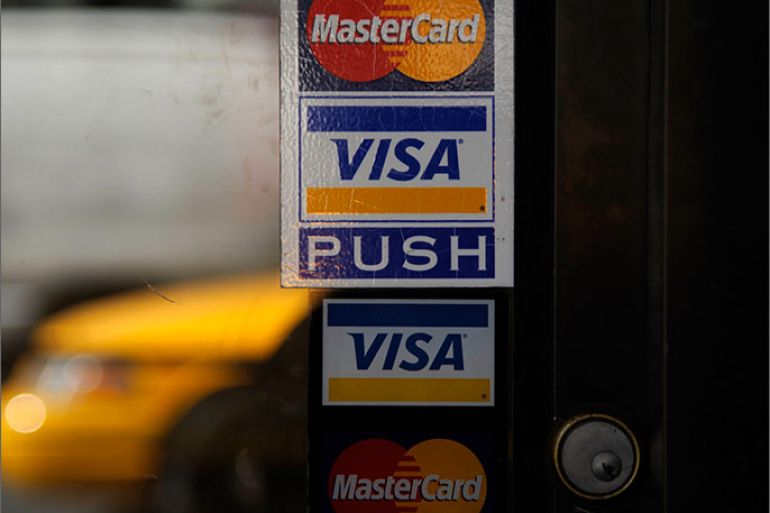 epa03165730 The Visa and Mastercard logo are displayed in store fronts in New York City, New York, USA, 30 March, 2012. Law enforcement officials are investigating what appears to be a massive theft of U.S. consumers' credit card data, MasterCard and Visa confirmed Friday. The computer security expert who first reported the theft said it might involve as many as 10 million MasterCard and Visa accounts, making it one of the largest known credit card heists. EPA/PETER FOLEY EPA/PETER FOLEY