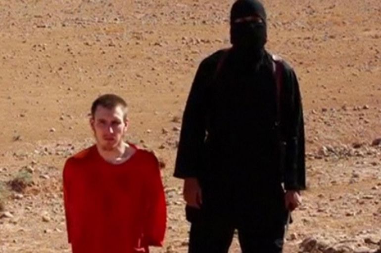 A masked man stands next to a kneeling man identified as U.S. citizen Peter Edward Kassig (L), in this still image taken from video released by Islamic State militants fighting in Iraq and Syria, on October 3, 2014. U.S. officials confirmed that an American named Kassig was being held by the militants and said they had no reason to doubt the authenticity of the video. The video also purported to show the beheading of British citizen Alan Henning, who had been abducted in northwest Syria in December 2013, the fourth such killing of a Westerner by Islamic State, which has seized large swaths of Iraq and Syria and has been blamed for a wave of sectarian violence. REUTERS/Social Media Website via Reuters TV (UNKNOWN - Tags: CIVIL UNREST CRIME LAW CONFLICT POLITICS) ATTENTION EDITORS - THIS PICTURE WAS PROVIDED BY A THIRD PARTY. REUTERS IS UNABLE TO INDEPENDENTLY VERIFY THE AUTHENTICITY, CONTENT, LOCATION OR DATE OF THIS IMAGE. NO SALES. NO ARCHIVES. FOR EDITORIAL USE ONLY. NOT FOR SALE FOR MARKETING OR ADVERTISING CAMPAIGNS. THIS PICTURE IS DISTRIBUTED EXACTLY AS RECEIVED BY REUTERS, AS A SERVICE TO CLIENTS