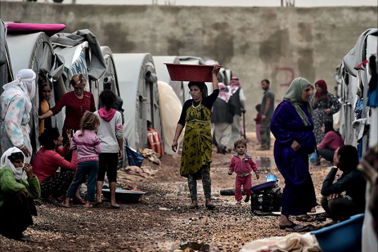 Syrian Kurdish refugees go about their daily chores on October 11, 2014 in a camp in the town of Suruc in Sanliurfa province. About 300,000 Syrian Kurd refugees have fled the town of Ain al-Arab, known as Kobane by the Kurds, after an almost one month assault by Islamic State militants. The United States reported "progress" on October 10 in pressing Turkey to participate in the fight against the Islamic State group, noting a pledge from Ankara to train
