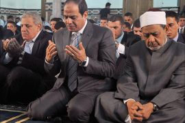 A handout picture released by the Egyptian Presidency shows Egypt's President Abdel Fattah al-Sisi (C), along with Grand Imam of al-Azhar Shiekh Ahmed el-Tayeb (R) and Prime Minister Ibrahim Mahlab (L), performing prayers on the Muslim holiday of Eid al-Adha, or feast of sacrifice, in the capital Cairo on October 4, 2014. The religious festival, celebrated by a total of about 1.5 billion Muslims around the world in remembrance of Abraham's readiness to sacrifice his son to God, marks the end of the annual pilgrimage to Mecca. AFP PHOTO / HO /EGYPTIAN PRESIDENCY