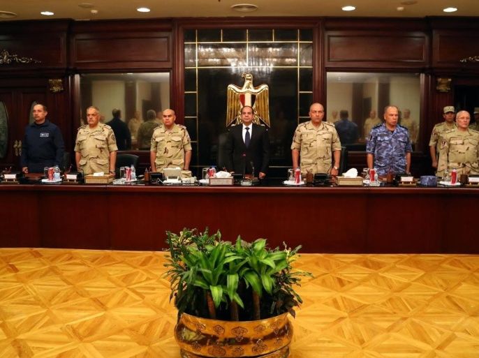 CAIRO, EGYPT - OCTOBER 25: Egyptian President Abdel-Fattah El-Sisi (C) and the other members of the National Defence Council stand in one minute's silence for deceased soldiers in the Sinai attacks, before the meeting of the National Defence Council starts, in Cairo, Egypt on 25 October, 2014. At least 30 soldiers were killed in attacks.
