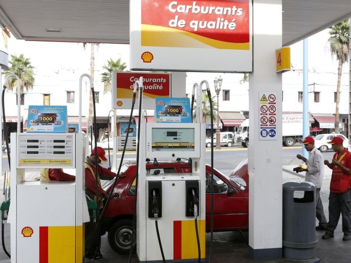 A Moroccan gas station attendant pumps gasoline into customer s car at a Shell station in Casablanca Thursday, Sept. 5, 2013. Morocco has announced a new system of pricing gasoline and diesel by linking it to the price of oil on the world's markets in an effort to cut its bloated subsidies bill.