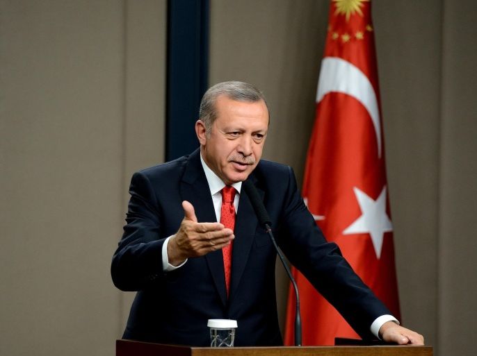 ANKARA, TURKEY - OCTOBER 22: Turkish President Recep Tayyip Erdogan makes a statement to the press before departing to Latvia for varied intercourses, at Esenboga International Airport in the capital Ankara, Turkey on October 22, 2014.
