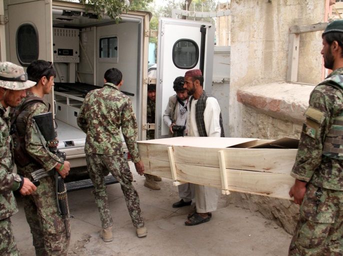 Afghan National Army (ANA) soldiers carry coffin containing body of their comrade who was killed in a suicide bomb attack in Wardak province, after the body was transported to Ghazni, Afghanistan, 12 October 2014. At least three Afghan soldiers and three civilians were killed when a suicide attacker detonated his explosives filled vehicle targeting ANA convoy in Wardak on 12 October.