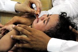 A health department worker applies a polio vaccine dose to a child in Peshawar, Pakistan, 31 May 2012. Reports state that the World Health Organization (WHO) has warned that if Pakistani authorities failed to contain the Polio virus, then several countries would be compelled to impose travel and visa restrictions to make sure that the virus do not spread to their countries. Polio cases over last month has taken the country's total number of poliomyelitis-affected children to five in 2012, officials said. Most of the 198 cases recorded in 2011 were notified in the north western part of the country where local religious clerics and pro-Taliban lobby are reportedly trying to convince residents that the US-manufactured polio drops were designed to sterilize Pakistanis and reduce the Muslim population. EPA/ARSHAD ARBAB