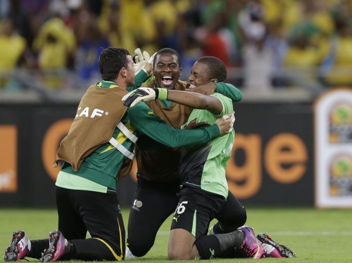 FILE- In this file photo dated Sunday, Jan. 27, 2013, South Africa's goalkeeper Itumeleng Khune, right, celebrates with fellow goalkeepers Wayne Sandilands, left, and Senzo Meyiwa, center, after drawing with Morocco to advance to the quarterfinals of the African Cup of Nations, in Durban, South Africa. According to reports Sunday Oct. 26, 2014, soccer club Orlando Pirates says 27-year old South Africa goalkeeper Senzo Meyiwa died during a shooting incident in South Africa. (AP Photo/Rebecca Blackwell, FILE)