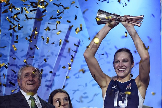 US Christa Harmotto Dietzen holds the trophy after winning the Volleyball Women's World Championship final match USA vs China in Milan on October 12, 2014. AFP PHOTO / OLIVIER MORIN