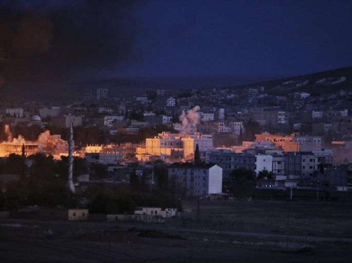 The light of an explosion from an airstrike by the US-led coalition in Kobani, Syria, lights part of the town as seen from a hilltop on the outskirts of Suruc, at the Turkey-Syria border, Monday, Oct. 20, 2014 Kobani, also known as Ayn Arab, and its surrounding areas, has been under assault by extremists of the Islamic State group since mid-September and is being defended by Kurdish fighters. (AP Photo/Lefteris Pitarakis)