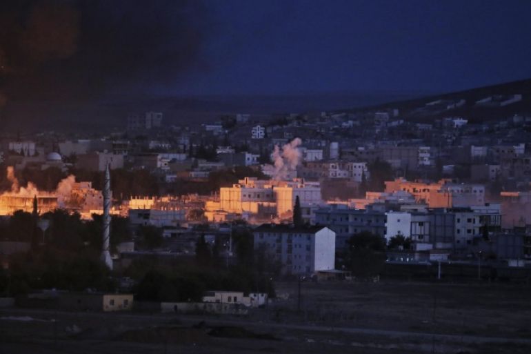 The light of an explosion from an airstrike by the US-led coalition in Kobani, Syria, lights part of the town as seen from a hilltop on the outskirts of Suruc, at the Turkey-Syria border, Monday, Oct. 20, 2014 Kobani, also known as Ayn Arab, and its surrounding areas, has been under assault by extremists of the Islamic State group since mid-September and is being defended by Kurdish fighters. (AP Photo/Lefteris Pitarakis)