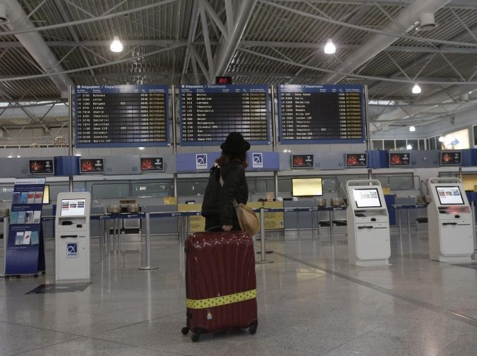 A commuter looks at an announcement board inside the Athens Eleftherios Venizelos airport during a 24-hour general strike in Athens, Greece, 27 November 2014. Air, rail and ferry transport were disrupted across Greece on 27 November with many public services shutting down as unions held a 24-hour nationwide strike to protest ongoing austerity measures. Dozens of flights were cancelled or rescheduled as air traffic controllers walked off the job at midnight.