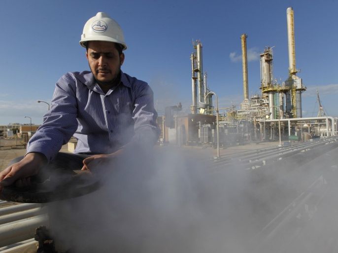 FILE - In this Feb. 26, 2011, file photo, an employee works at a refinery inside the Brega oil complex, in Brega, eastern Libya. OPEC produces one-third of the world’s oil and, in theory, at least, can affect global oil prices depending on how much oil it decides to sell. In reality, OPEC member countries have different, often conflicting priorities and don’t adhere to the cartel’s official targets for production. (AP Photo/Hussein Malla, File)