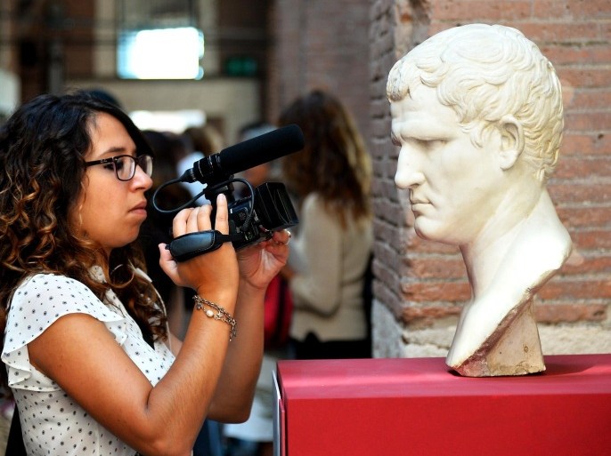 A visitor looks at a head of Marcus Vipsanius Agrippa, a Roman statesman and general at the Trajan's Market (Mercati di Traiano) museum on September 23, 2014 in Rome, where the exhibition 'The keys of Rome. The city of Augustus' runs till May 10, 2015. 'Keys To Rome' is an international exhibition on the city of Augustus and the Roman Empire organized in four locations (Rome, Alexandria, Amsterdam, and Sarajevo) by the European network of Virtual Museums, V-MUST, coordinated by the Italian National Council of Researches. AFP PHOTO / VINCENZO PINTO