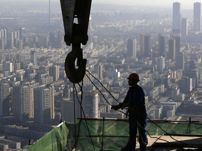 A worker operates at a construction site on the 68th storey of a building in Shenyang, Liaoning province, October 16, 2014. September industrial output, retail sales and investment numbers will be released on Oct 21 along with third-quarter GDP, which is expected to show the world's second-largest economy grew at its weakest pace in more than five years as sluggish domestic demand and a rapidly cooling property market weighed on other sectors. REUTERS/Stringer (CHINA - Tags: BUSINESS CONSTRUCTION) CHINA OUT. NO COMMERCIAL OR EDITORIAL SALES IN CHINA