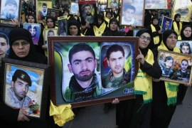 Lebanese Hezbollah supporters carry pictures of Hezbollah fighters who were killed in battle in Syria and against Israel, during a rally to mark the 13th day of Ashoura, in the southern market town of Nabatiyeh, Lebanon, Friday, Nov. 7, 2014. Shiites mark Ashoura, the tenth day of the Islamic month of Muharam, to commemorate the Battle of Karbala in the 7th century when Imam Hussein, a grandson of Prophet Muhammad, was killed in present-day Iraq. (AP Photo/Mohammed Zaatari)