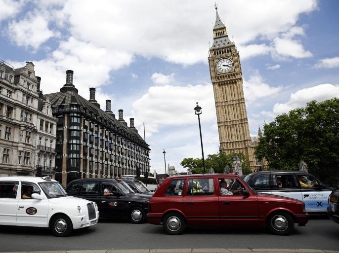 Rows of London taxi cabs stand parked outside Big Ben, right, and Portcullis House, center, during a protest against Uber Technologies Inc.'s car sharing service in London, U.K., on Wednesday, June 11, 2014. Traffic snarled in parts of Madrid and Paris today, with a total of more than 30,000 taxi and limo drivers from London to Berlin blocking tourist centers and shopping districts.