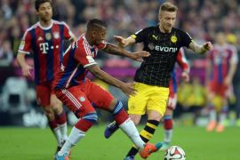 Munich's Jérome Boateng and Dortmund's Marco Reus (R) vie for the ball during the German Bundesliga soccer match between FC Bayern Munich and Borussia Dortmund at Allianz Arena in Munich, Germany, 01 November 2014.(ATTENTION: Due to the accreditation guidelines, the DFL only permits the publication and utilisation of up to 15 pictures per match on the internet and in online media during the match.)