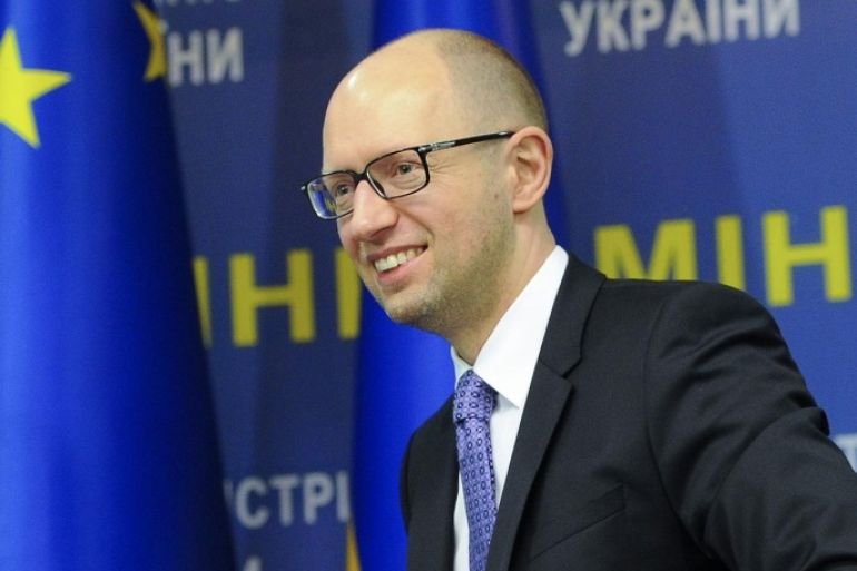 Ukraine's Prime Minister Arseniy Yatsenyuk smiles during a press conference in Kiev, Ukraine, Wednesday, Oct. 29, 2014. The pro-European political parties, including Yatsenyuk's Popular Front, that secured most votes in Sunday's parliamentary elections are negotiating to form a coalition government. (AP Photo/Andrew Kravchenko, Pool)