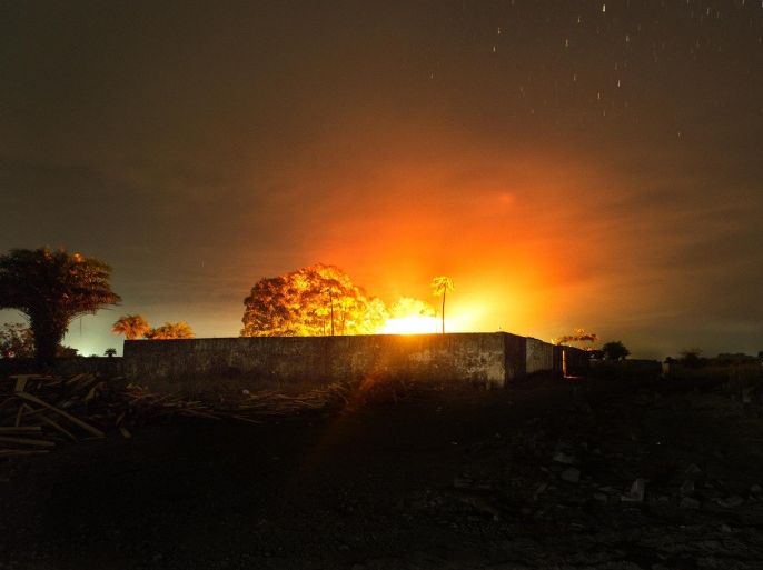 MONROVIA, LIBERIA -SEPTEMBER 15: The glow from a crematorium fire lights up the night sky where bodies of people who died from Ebola are cremated on Sunday September 14, 2014 in Monrovia, Liberia. The crematorium was built by the Indian Embassy but has now been transformed to cremate, up to 120 people at a time, who have died from Ebola. Liberians have been living under extreme conditions as the Ebola virus worsens.
