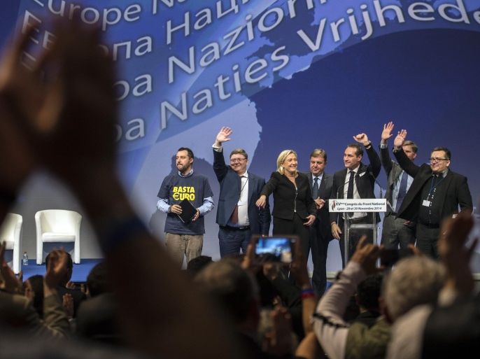 French far-right Front National leader Marine Le Pen, center, poses with European far-right party members during the 15th congress of the party, in Lyon, central France, Saturday, Nov. 29, 2014. Marine Le Pen is eyeing French presidential elections in 2017 and has worked to scrub the stigma from the far-right anti-immigration party, which is now a rising political force in France. But tensions have risen between Marine Le Pen and her father, Jean-Marie Le Pen, who led the National Front for nearly four decades and has been convicted of racism and anti-Semitism, as the new leadership seeks an image change. (AP Photo/Laurent Cipriani)