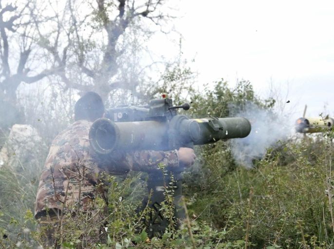 A rebel fighter fires an anti-tank missile towards forces loyal to Syria's President Bashar al-Assad in the Jabal al-Akrad area in Syria's northwestern Latakia province November 25, 2014. REUTERS/Alaa Khweled (SYRIA - Tags: POLITICS CIVIL UNREST CONFLICT)