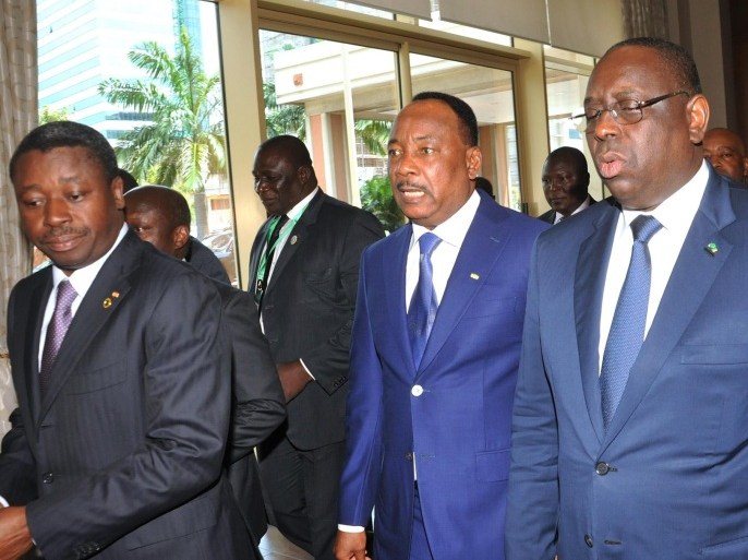 Togo's president Faure Gnassingbe, Niger's president Mahamadou Issoufou and Senegal's president Macky Sall speak as they arrive arrive at the conference hall of the Movepick Ambassador Hotel during an Economic Community of West Africa States (ECOWAS) summit on November 6, 2014 in Accra. Burkina Faso's political parties and civil society groups met for a second day on November 6 to agree on a civilian leader to lead a transition government after the ousting of president Blaise Compaore. AFP PHOTO / STRINGER