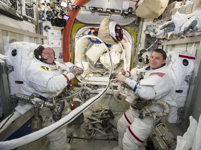 NASA astronauts Reid Wiseman (R) and Barry Wilmore work inside the International Space Station on October 1, 2014. The two spacewalking NASA astronauts hustled and muscled through an electrical repair job outside the International Space Station on October 15, 2014 completing their task with two minutes to spare. Picture taken on October 1, 2014. REUTERS/NASA/Handout (OUTER SPACE - Tags: SCIENCE TECHNOLOGY) FOR EDITORIAL USE ONLY. NOT FOR SALE FOR MARKETING OR ADVERTISING CAMPAIGNS. THIS IMAGE HAS BEEN SUPPLIED BY A THIRD PARTY. IT IS DISTRIBUTED, EXACTLY AS RECEIVED BY REUTERS, AS A SERVICE TO CLIENTS