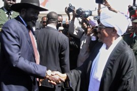 KHARTOUM, SUDAN - NOVEMBER 04: South Sudanese President Salva Kiir (L) is welcomed by his Sudanese counterpart Omar al-Bashir (R) upon his arrival at the Khartoum International Airport on November 4, 2014 in Khartoum, Sudan.