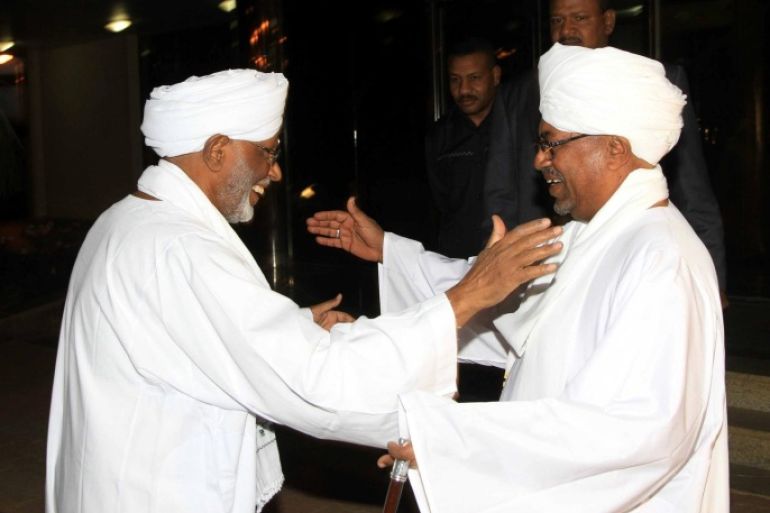KHARTOUM, SUDAN - MARCH 14: Sudanese President Omar al-Bashir (R) receives Popular Congress Party (PCP) leader Hassan al-Turabi (L) in Khartoum, Sudan, on March 14, 2014. President Omar al-Bashir and opposition leader Hassan al-Turabi agreed Friday that political dialogue should include all parties, regardless of their influence in Sudan's political arena. The two leaders haven't officially met since 1999, with al-Turabi since having become one of al-Bashir's most vocal critics.
