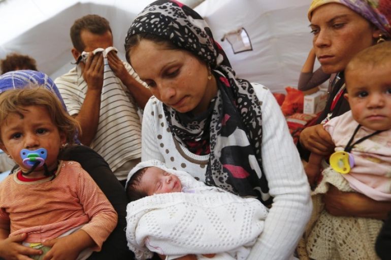 Kurdish Syrian refugees are seen with children inside a temporary medical facility for children on the Turkish-Syrian border near the southeastern town of Suruc in Sanliurfa province, in this September 24, 2014 file photo. Reuters photographers have chronicled Kurdish refugee crises over the years. In 1991 Srdjan Zivulovic documented refugees in Cukurca who had escaped a military operation by Saddam Hussein's government in Iraq aimed at "Arabising" Kurdish areas in the north. Hundreds of thousands fled into Turkey and Iran. Images shot in recent months show familiar scenes as crowds of people flee Islamic State militants in Syria. There are as many as 30 million Kurds, spread through Turkey, Iraq, Syria and Iran. Most Kurds are Sunni Muslims, but tend to feel more loyalty to their Kurdishness, rather than their religion. REUTERS/Murad Sezer/Files (TURKEY - Tags: SOCIETY IMMIGRATION POLITICS CONFLICT) ATTENTION EDITORS: PICTURE 18 OF 30 PICTURES FOR WIDER IMAGE STORY 'KURDISH REFUGEES - THEN AND NOW'SEARCH 'CUKURCA' FOR ALL IMAGES