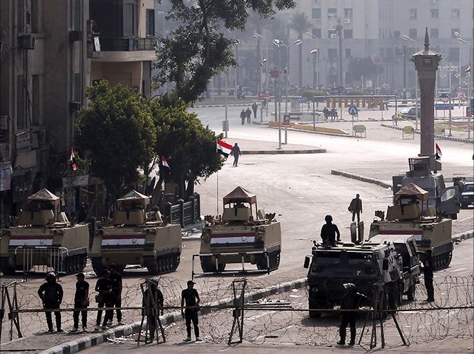 epa04509402 Egyptian army soldiers and armored vehicles block a road leading to Tahrir Square, one day after a court dismissed murder charges against former president Hosni Mubarak in Cairo, Egypt, 30 November 2014. Two people were killed in clashes between police and demonstrators in Cairo after the court verdict. Nine people were wounded in the unrest that erupted near central Cairo's Tahrir Square, the epicenter of a 2011 uprising against Mubarak. EPA