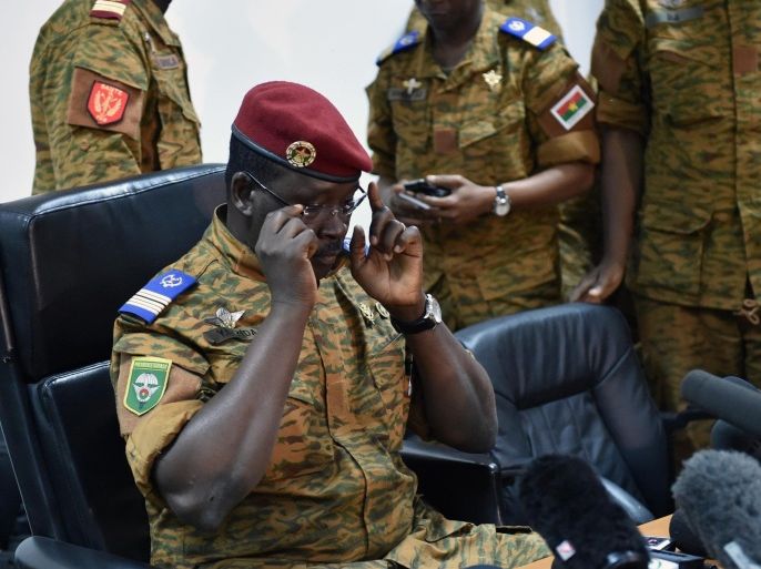 Isaac Zida (L), named by Burkina Faso's army as interim leader, sits before a press conference on November 6, 2014 in Ouagadougou. Burkina Faso's political parties and civil society groups met for a second day on November 6 to agree on a civilian leader to lead a transition government after the ousting of president Blaise Compaore. Stormy talks between the military, politicians and democracy groups in Ouagadougou on on November 5 ended with an agreement for elections in November 2015.   AFP PHOTO / ISSOUF SANOGO