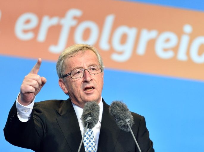 The Christian Democratic frontrunner Jean-Claude Junker speaks during an election campaign event for the European election on 25 May 2014 in Worms, Germany, 24 May 2014. Letters in background read "successful". (AP Photo/dpa,Uwe Anspach)