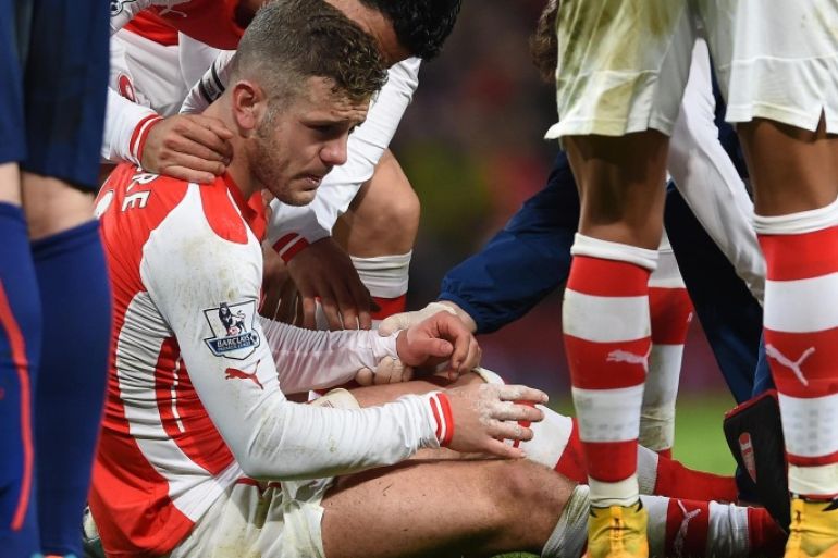Arsenal’s Jack Wilshere sits up after being injured during the English Premier League soccer match between Arsenal and Manchester United at the Emirates Stadium, London, Saturday, Nov. 22, 2014. (AP Photo/Tim Ireland)