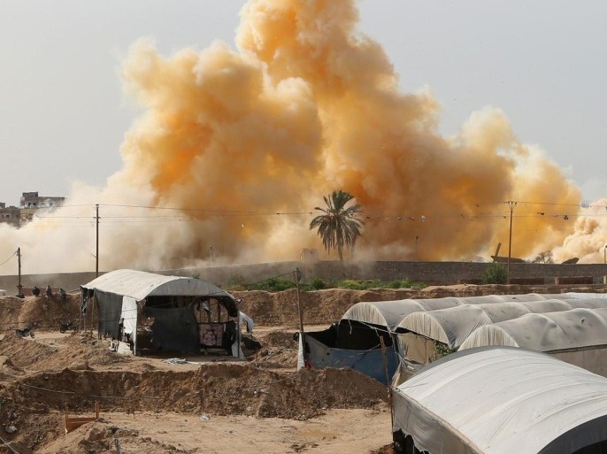 Smoke rises after a house was blown up during a military operation by Egyptian security forces in the Egyptian city of Rafah near the border with southern Gaza Strip on November 2, 2014, as Egypt began setting up a buffer zone along the border with the Hamas-run territory to prevent militant infiltration and arms smuggling following a wave of deadly attacks. The move, which is set to result in the demolition of hundreds of homes, comes after a suicide bombing in the Sinai Peninsula killed at least 30 soldiers on October 24, 2014. PHOTO AFP PHOTO/ SAID KHATIB