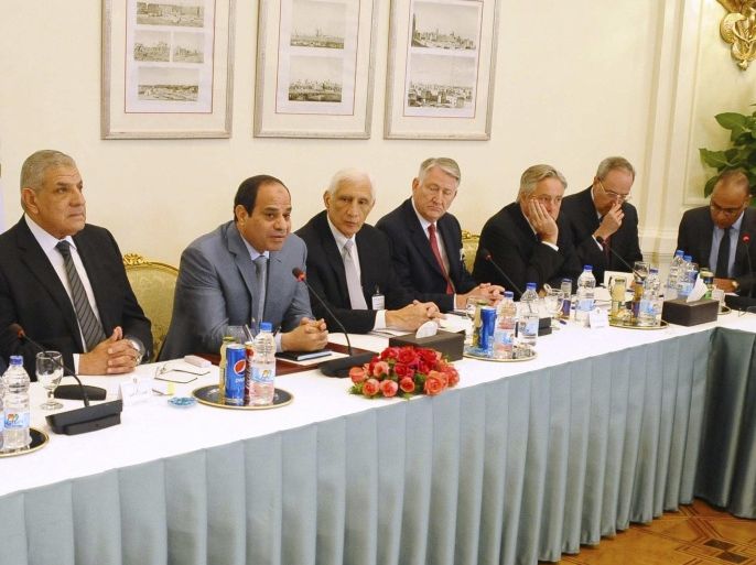 Egyptian President Abdel Fattah al-Sisi (2nd L) and Egypt's Prime Minister Ibrahim Mehleb (L) speak with U.S. businessmen and representatives of U.S. companies at the Presidential Palace in Cairo in this November 10, 2014 handout from the Egyptian Presidency. Sisi has told visiting U.S. businessmen that a parliamentary election will be held by March, his spokesman said on November 11, trying to reassure them that the delayed poll would not be put off indefinitely. Picture taken November 10, 2014. REUTERS/The Egyptian Presidency/Handout via Reuters (EGYPT - Tags: POLITICS BUSINESS) ATTENTION EDITORS - NO SALES. NO ARCHIVES. FOR EDITORIAL USE ONLY. NOT FOR SALE FOR MARKETING OR ADVERTISING CAMPAIGNS. THIS IMAGE HAS BEEN SUPPLIED BY A THIRD PARTY. IT IS DISTRIBUTED, EXACTLY AS RECEIVED BY REUTERS, AS A SERVICE TO CLIENTS. REUTERS IS UNABLE TO INDEPENDENTLY VERIFY THE AUTHENTICITY, CONTENT, LOCATION OR DATE OF THIS IMAGE